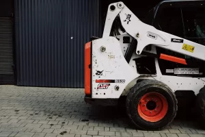 a white and orange skid steer vehicle