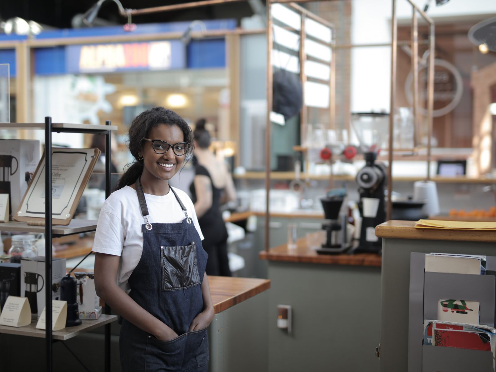 Business Loans 1 Smiling cafe owner standing in her shop - business loans for small businesses