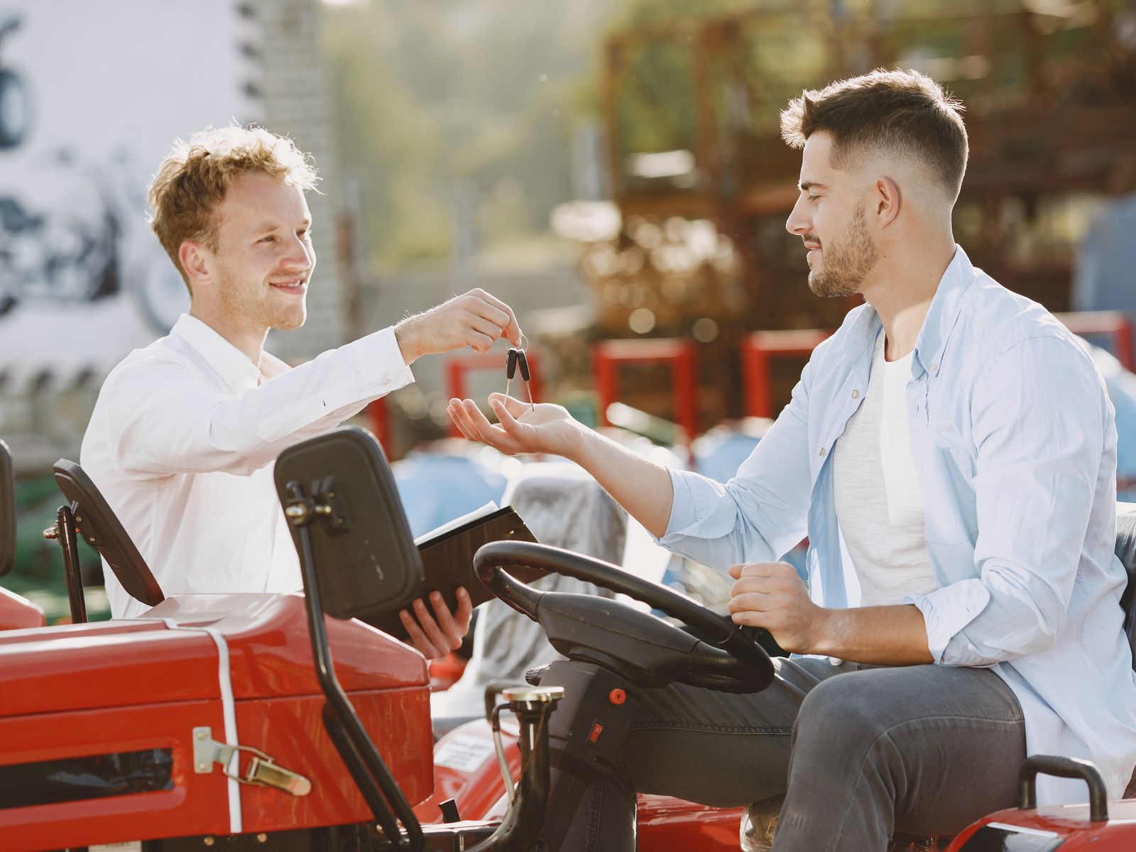 Become A Liberty Approved Equipment Vendor 1 Equipment dealer handing keys to a customer next to a new tractor