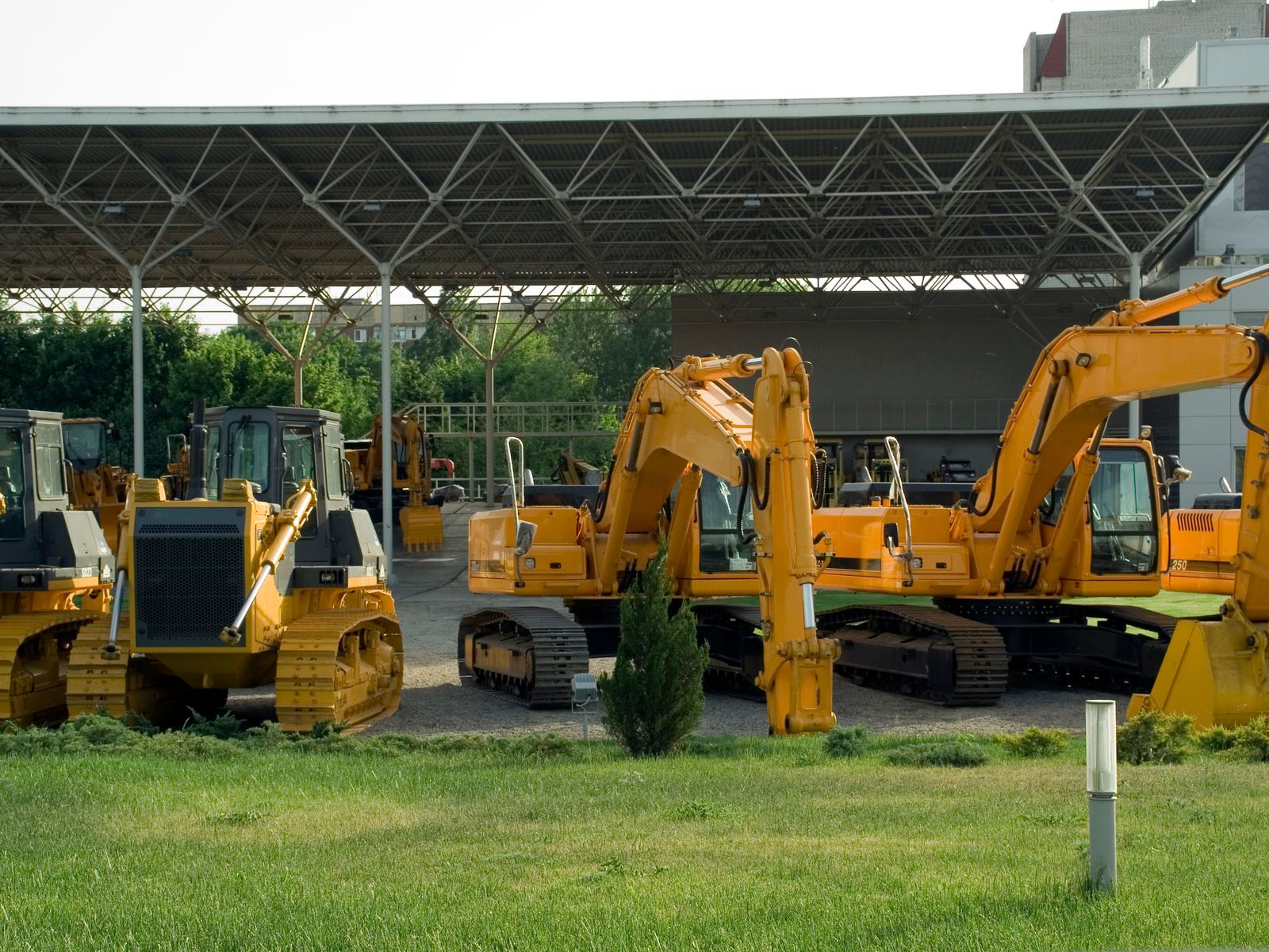 How Equipment Leasing Works 1 Excavators and bulldozers lined up at an equipment yard
