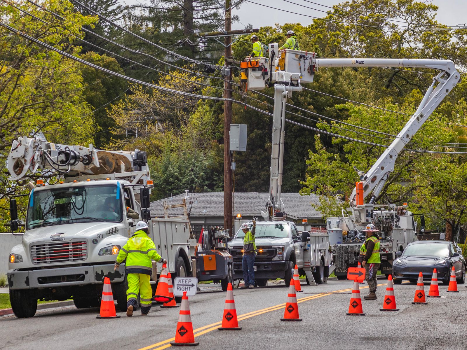 Utility service trucks and crew at work - service truck financing
