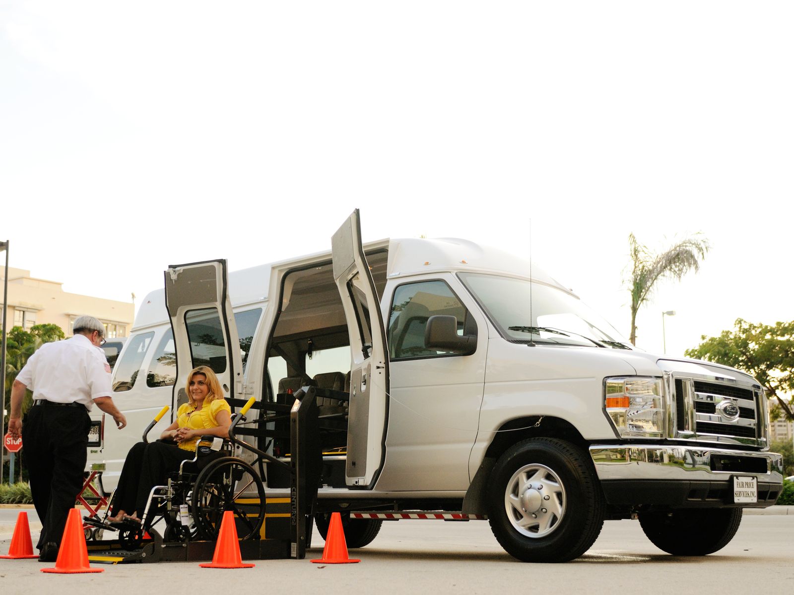 Wheelchair-accessible transport van with lift deployed for a passenger