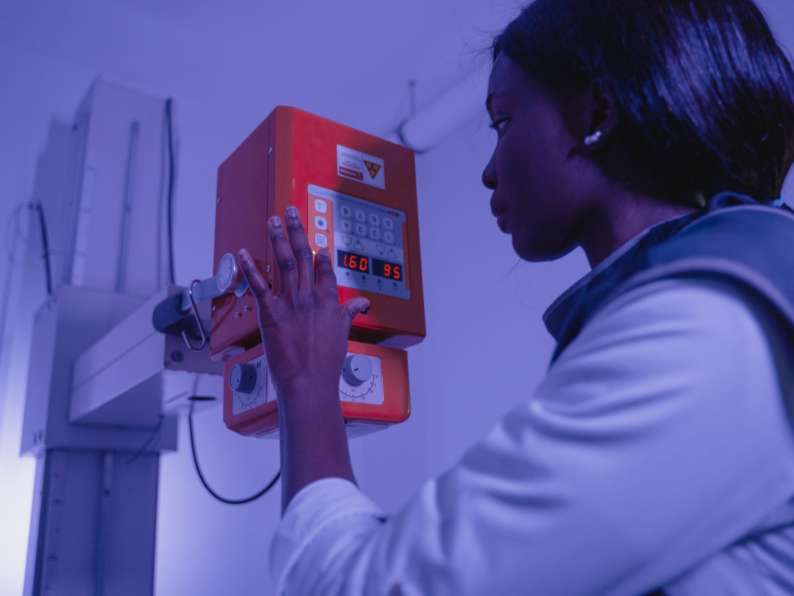 Radiology technologist positioning an x-ray tube